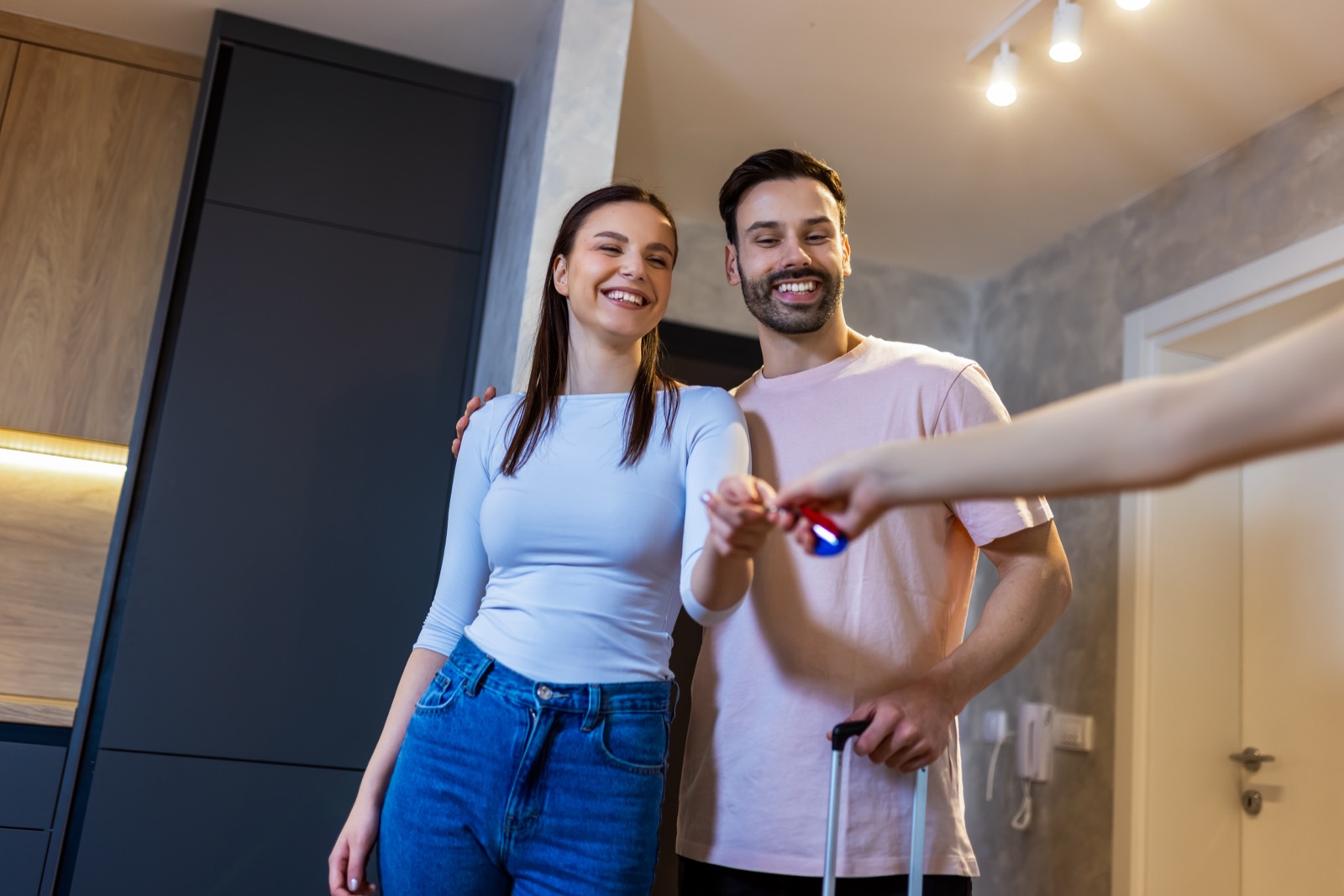 Two people receiving keys to new apartment